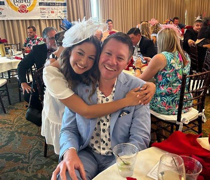 Board President and SERVPRO of Lakeland General Manager gets a big hug from his daughter at Camp Fire's Kentucky Derby Event