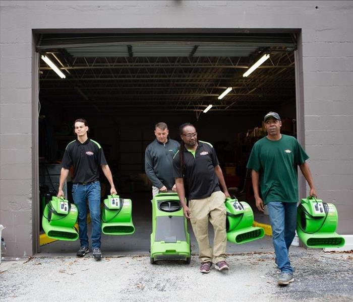 SERVPRO technicians carrying air movers