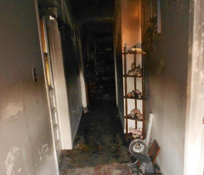 Extreme fire damage in the hallway of a house