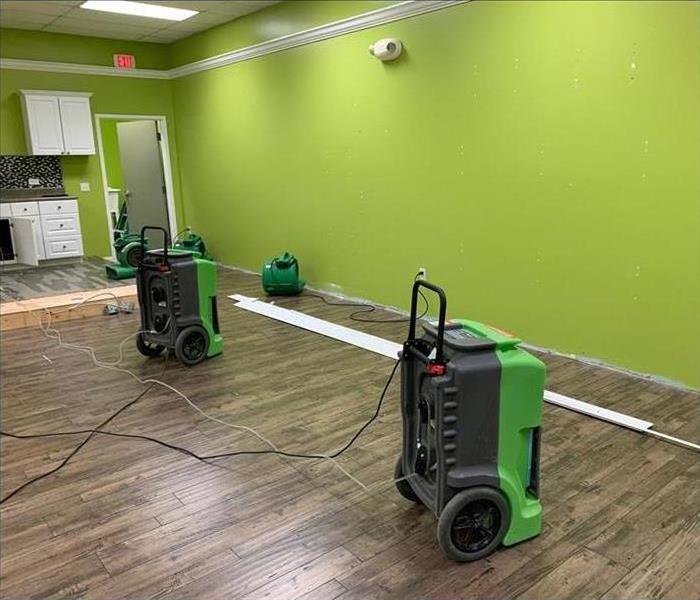 Restoration machines are cleaning an office after water damage