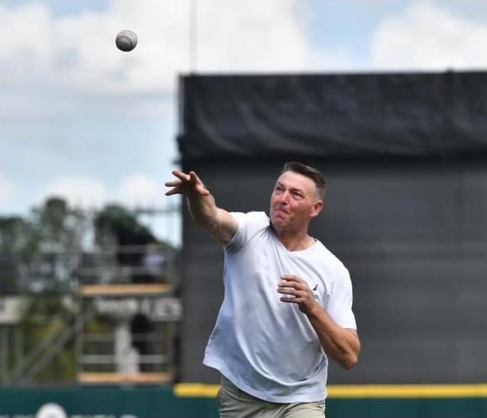 production manager throws out ceremonial first pitch at a spring training game