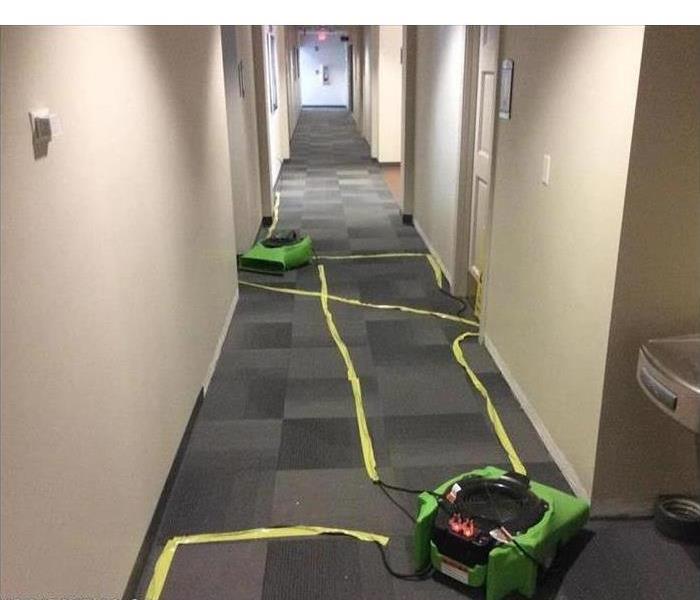 Air movers placed in a hallway of commercial building