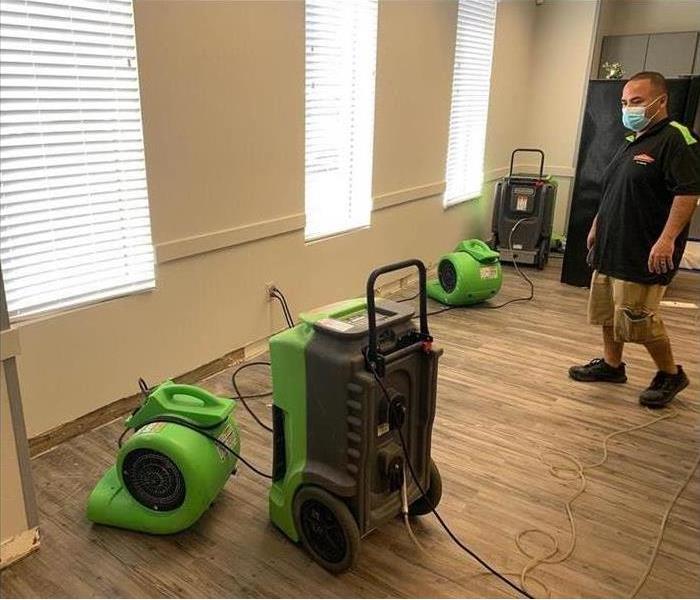 SERVPRO technician with drying equipment in a residential home